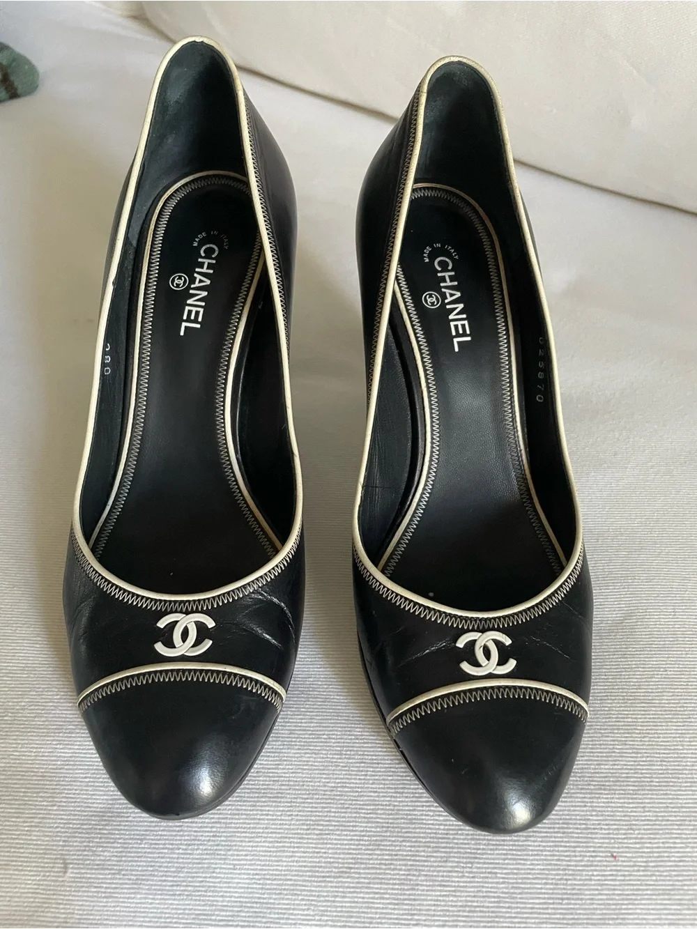 CHANEL Black Leather Cap-Toe Pumps with Cream Piping and CC Logo